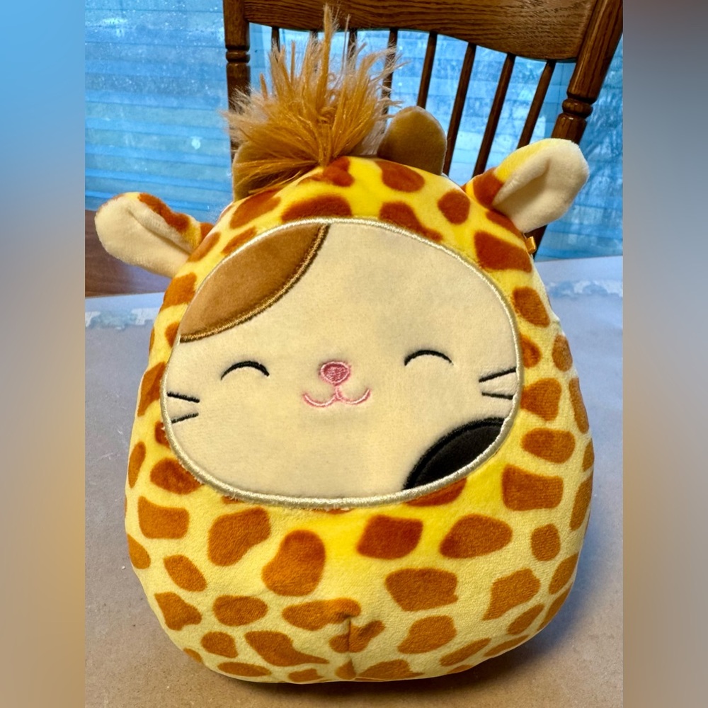 Cam the Cat squishmallow in a Giraffe costume